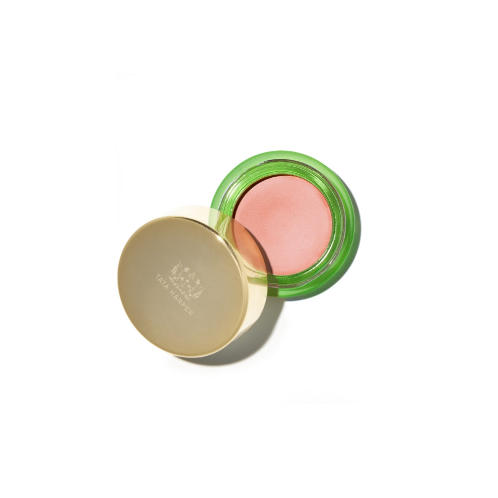 A compact blush with a golden lid, open to reveal a pink shade against a white background.