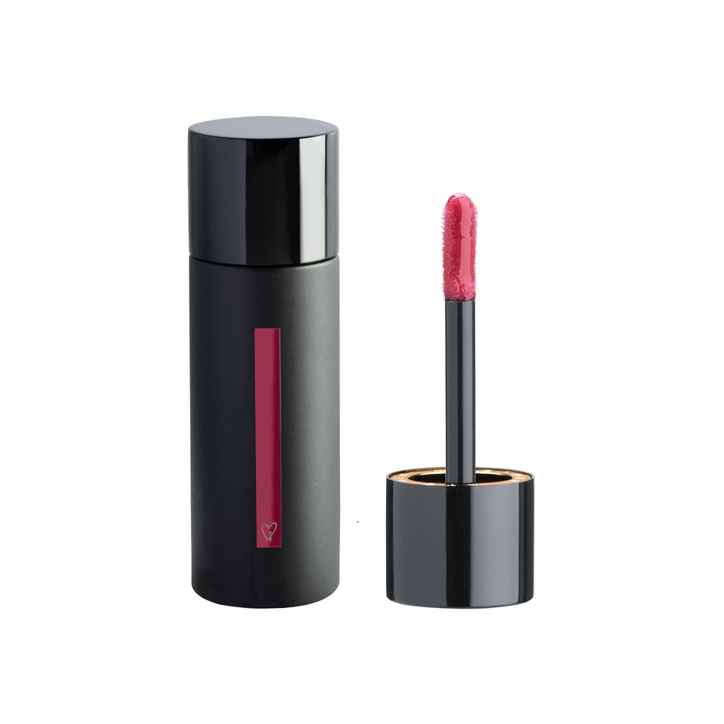 A tube of lipstick with its cap off, showing the applicator next to it.