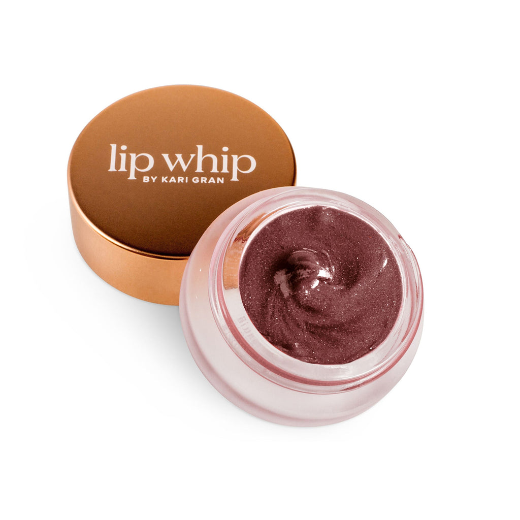 Open container of tinted lip balm with a gold lid next to it, isolated on a white background.