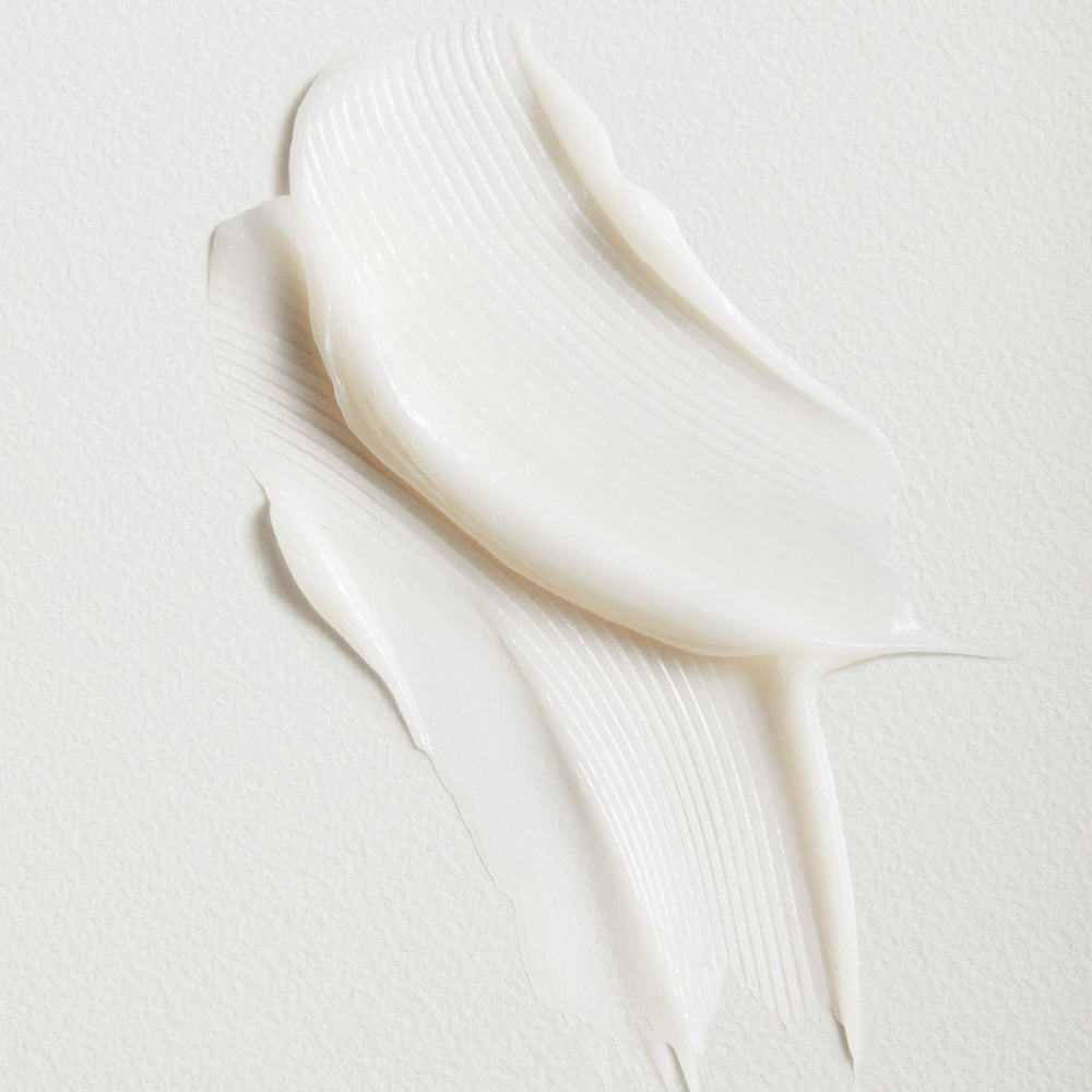 A smear of white cream against a textured background.