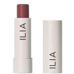 Ilia brand lipstick open next to its cap.