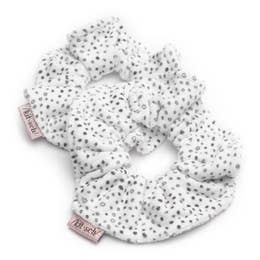 White scrunchie with black polka dots on a white background.