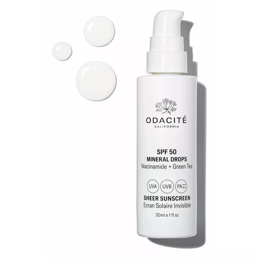 Odacite sunscreen bottle with dispensed spf 50 mineral drops next to it.