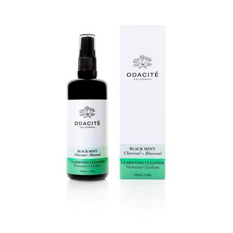 Bottle of odacite black mint cleanser next to its packaging box.