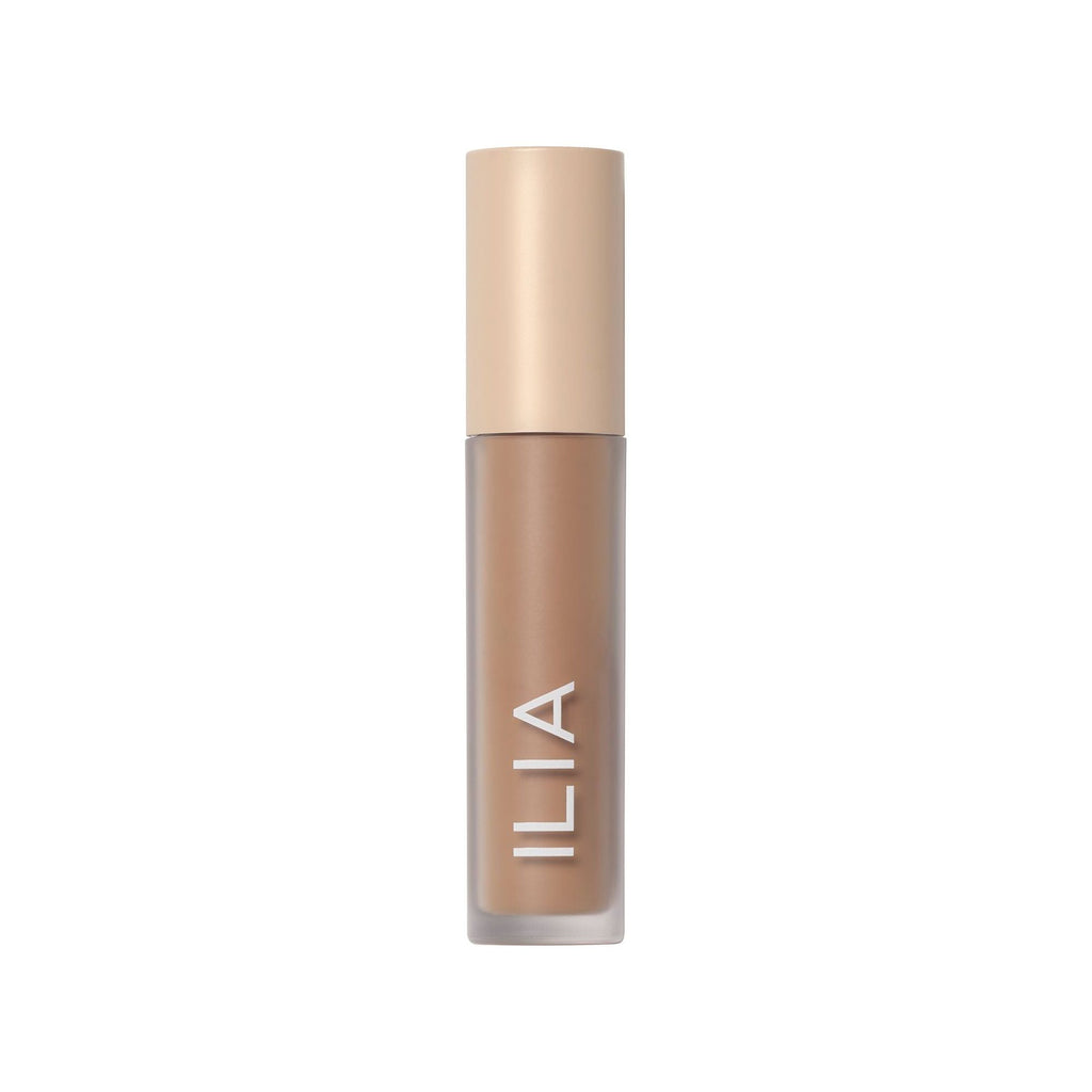 Ilia brand foundation in a beige bottle on a white background.