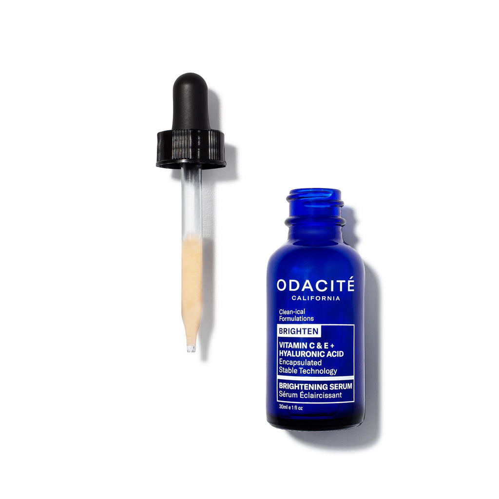 A bottle of odacite brightening serum with its dropper on a white background.