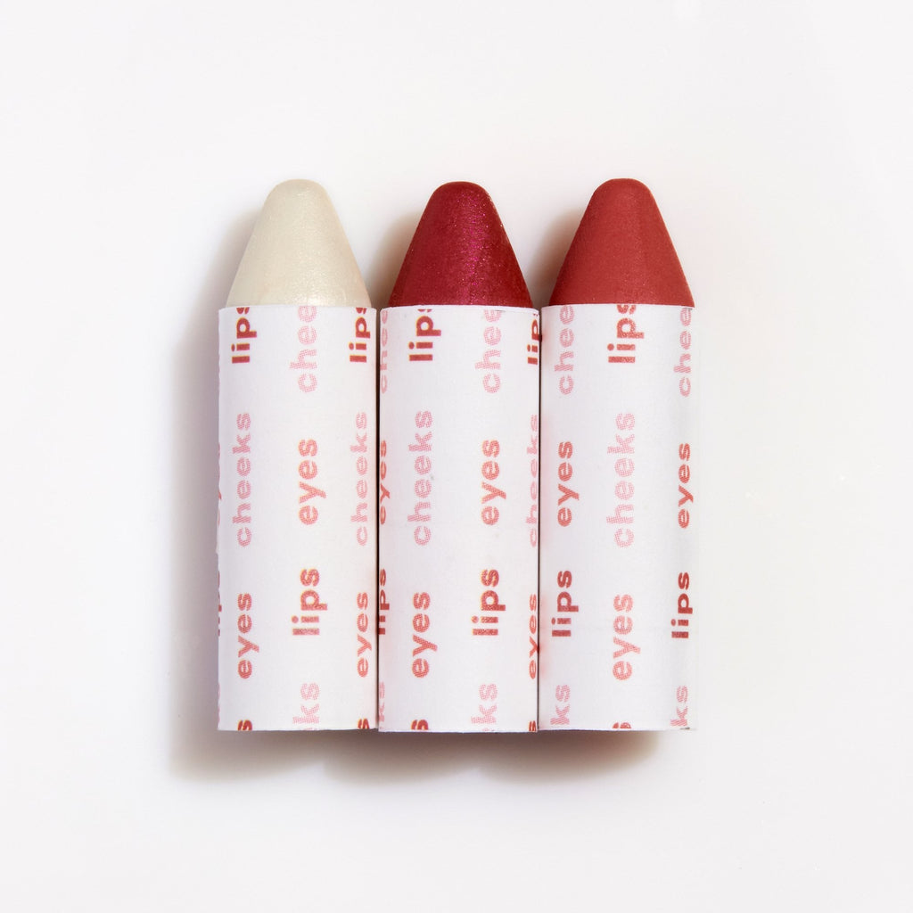 Three lipstick bullets with varying shades arranged in a row against a white background.