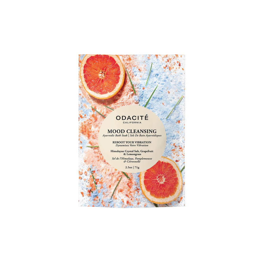 Product packaging for "odacite mood cleansing ayurvedic bath soak" with grapefruit slices and himalayan crystal salt in the background.