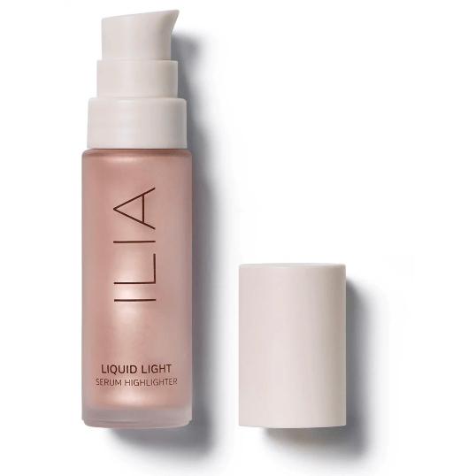 Bottle of ilia liquid light serum highlighter with its cap placed to the side.
