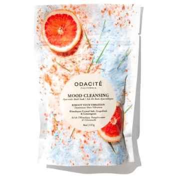 Packaging of odacite mood cleansing ayurvedic bath soak featuring grapefruit imagery and splattered design.