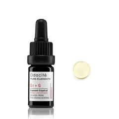 Bottle of odacite serum with dropper and a sample drop next to it on a white background.
