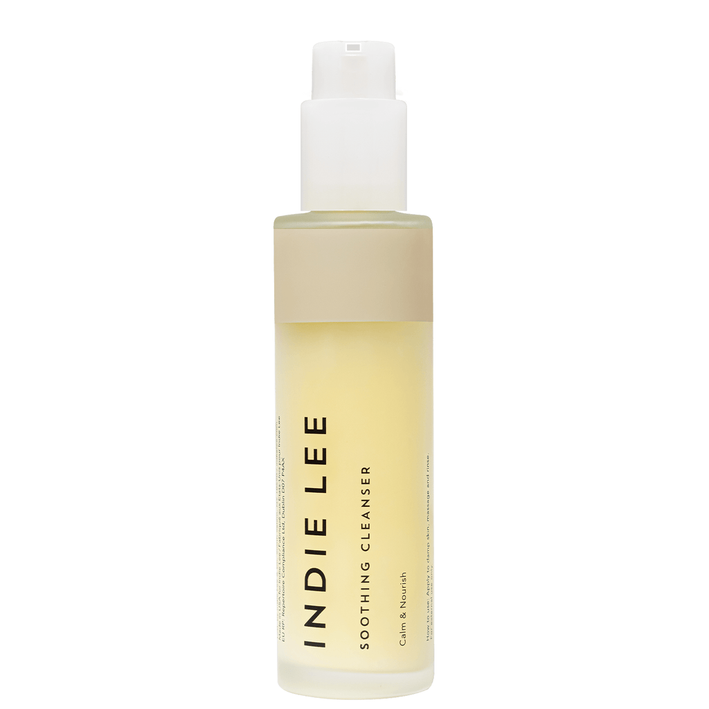 A bottle of indie lee soothing cleanser with pump dispenser.