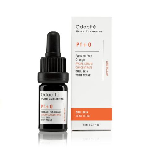 A bottle of odacite passion fruit and orange facial serum concentrate next to its packaging.
