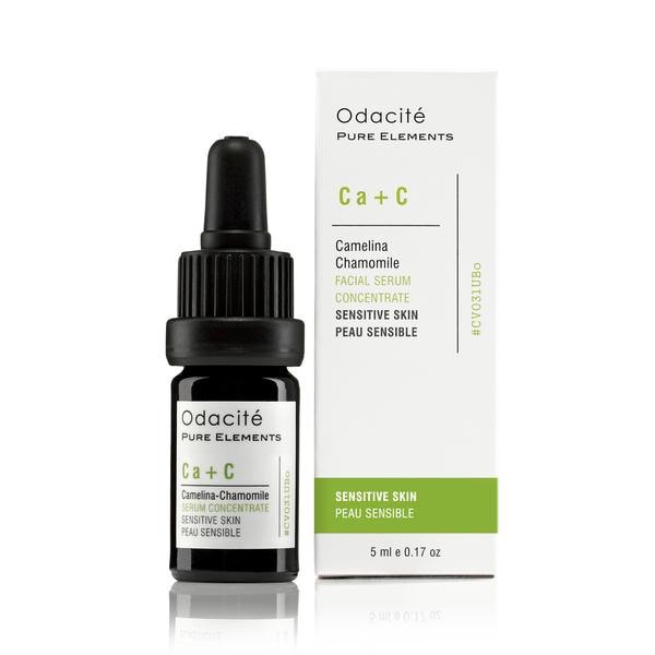 A bottle of odacite pure elements ca+c sensitive skin serum next to its packaging.
