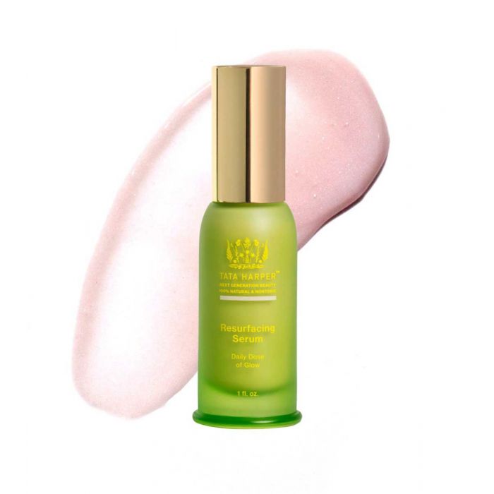 A green bottle of tata harper resurfacing serum with a swatch of the product alongside it.