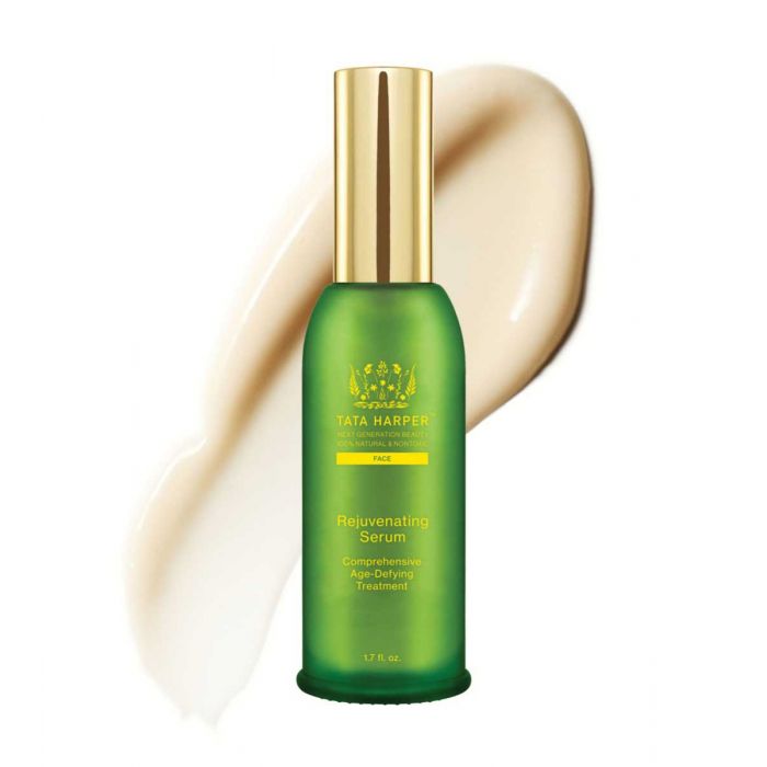 Green bottle of tata harper rejuvenating serum with a swatch of the product next to it.