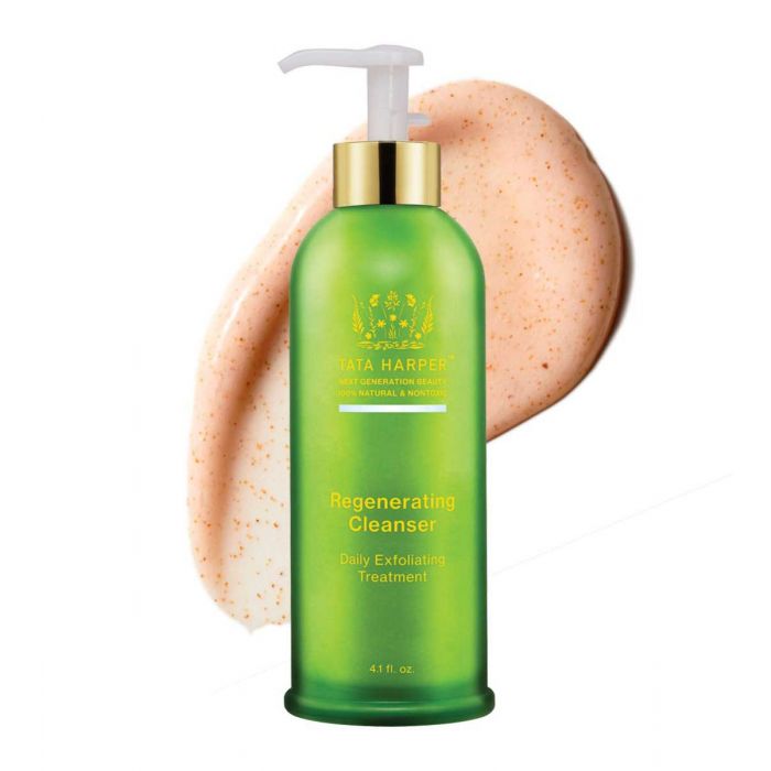 A bottle of tata harper regenerating cleanser with a sample of its exfoliating cream next to it.