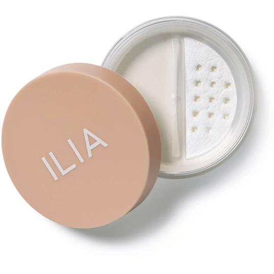Container of ilia brand translucent powder with a sifter lid, isolated on a white background.