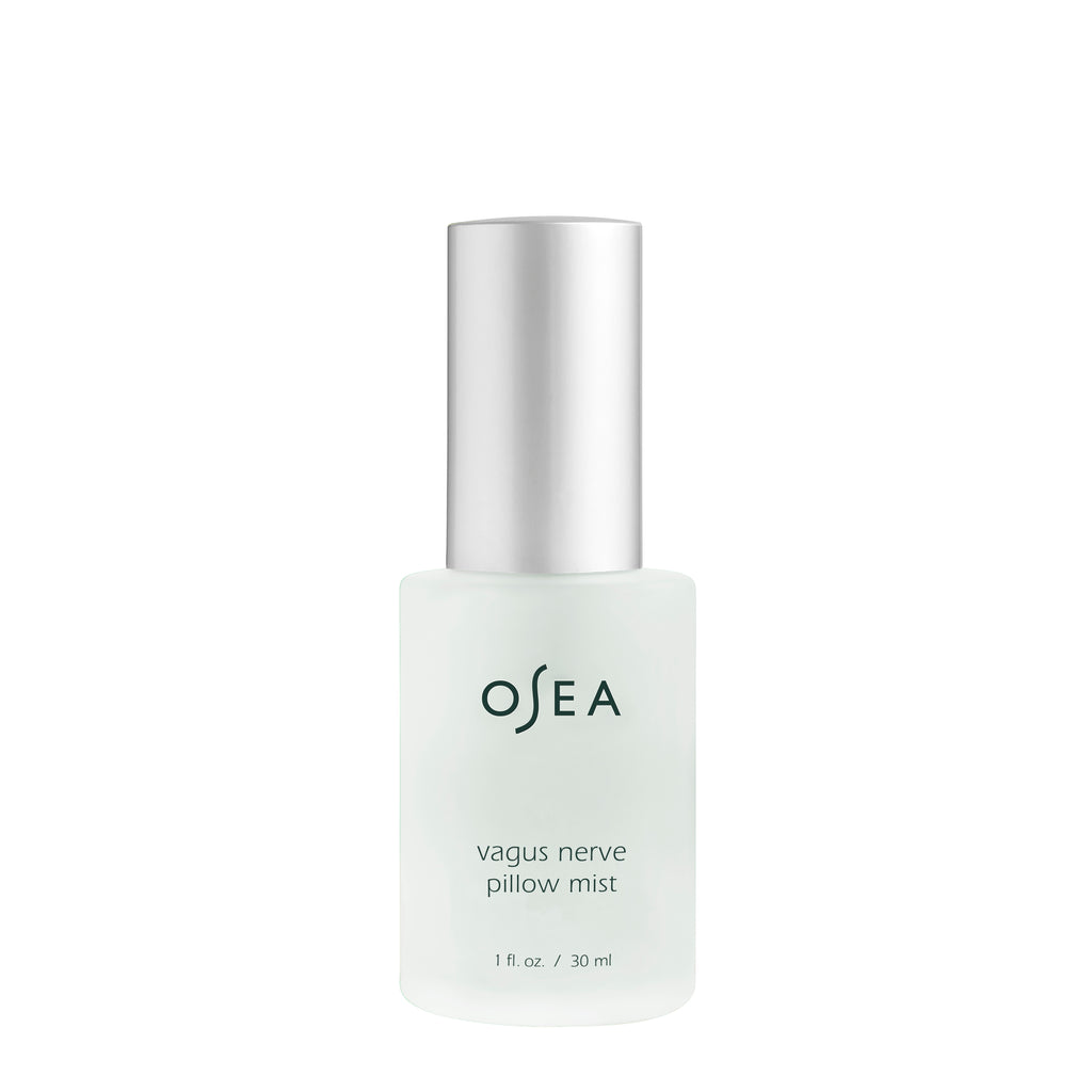 Opaque glass bottle of osea vagus nerve pillow mist with a silver cap, isolated on a white background.