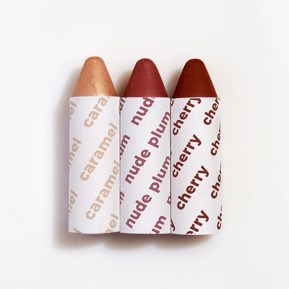 Three lipsticks in shades of nude, plum, and cherry with labeled casing.