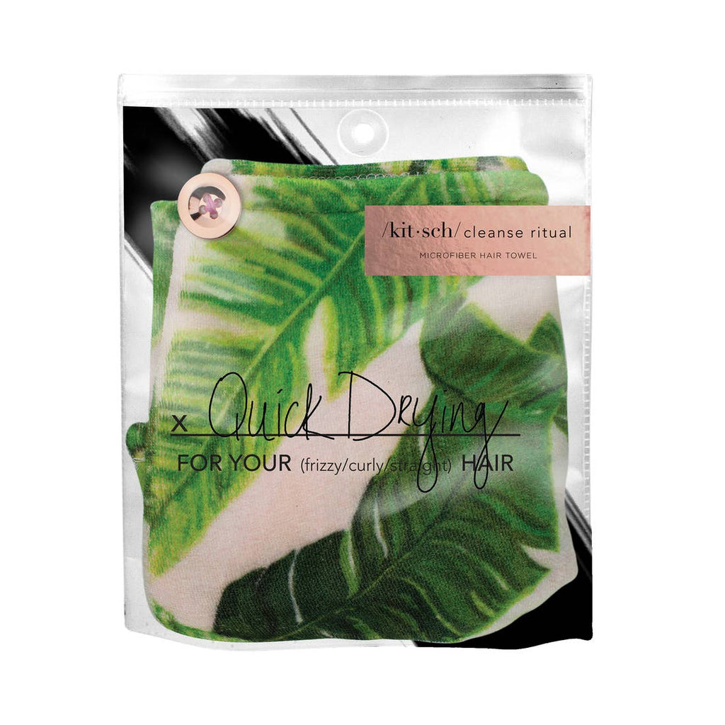 Microfiber hair towel in packaging with tropical leaf design, marketed for quick drying of frizzy, curly, and wavy hair.