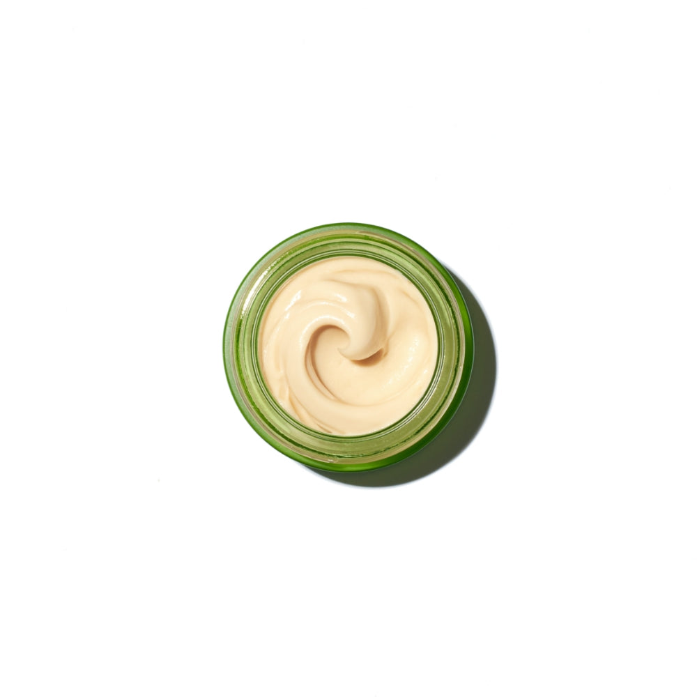Open jar of cream with a swirl texture on a white background.