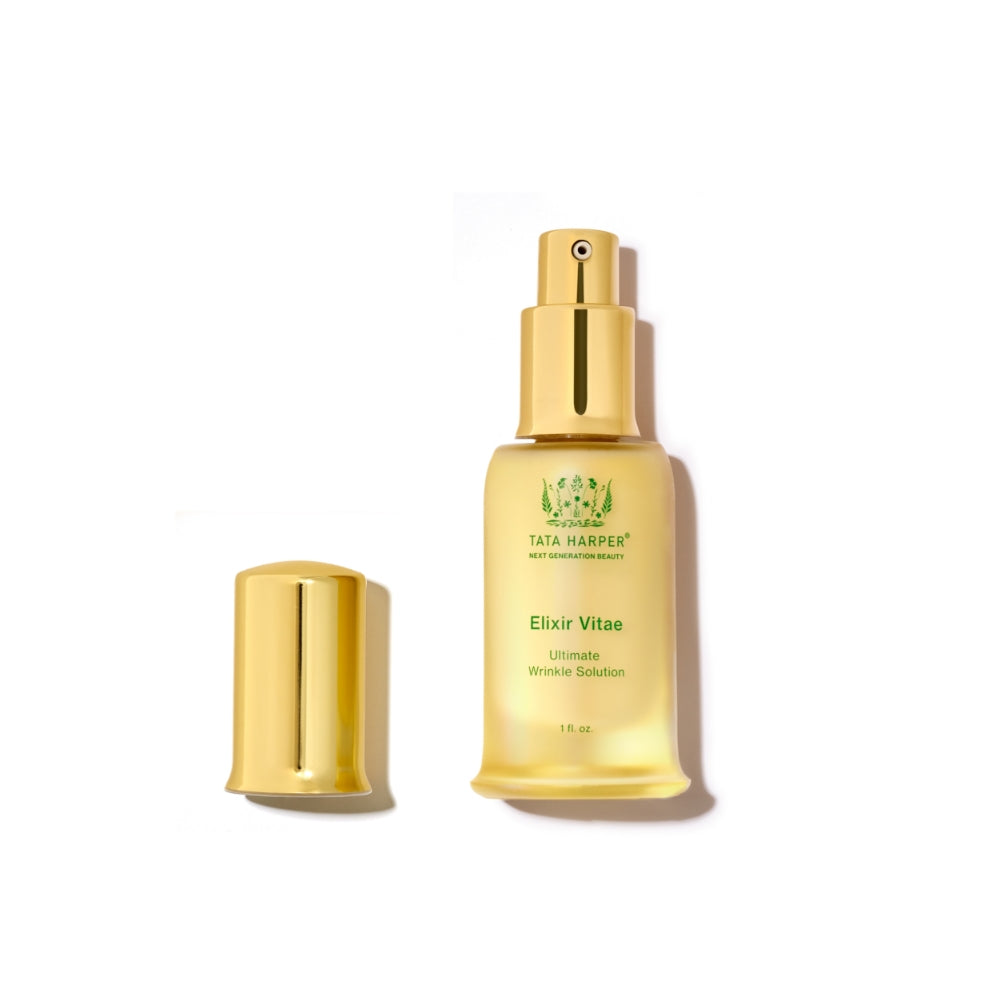 A bottle of tata harper elixir vitae ultimate wrinkle solution with its cap placed beside it on a white background.