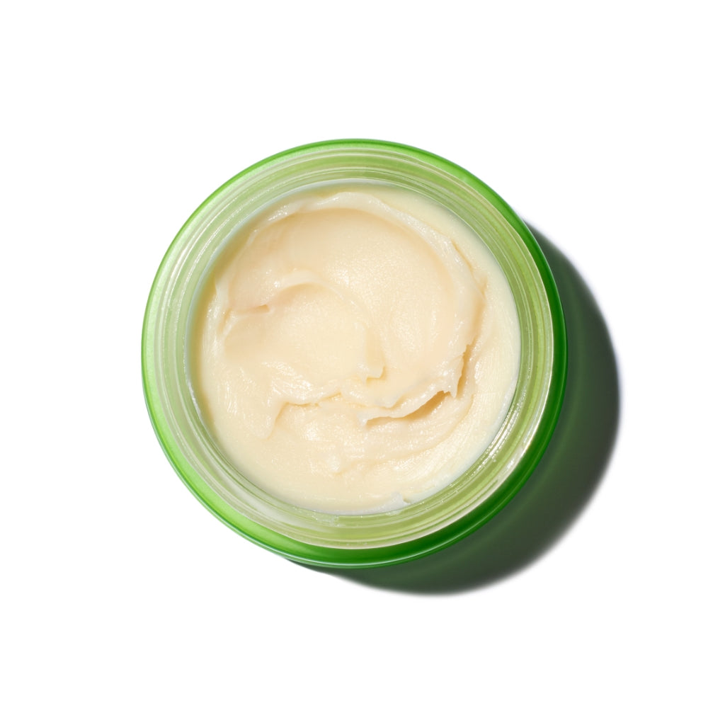 Open jar of cream with visible texture against a white background.