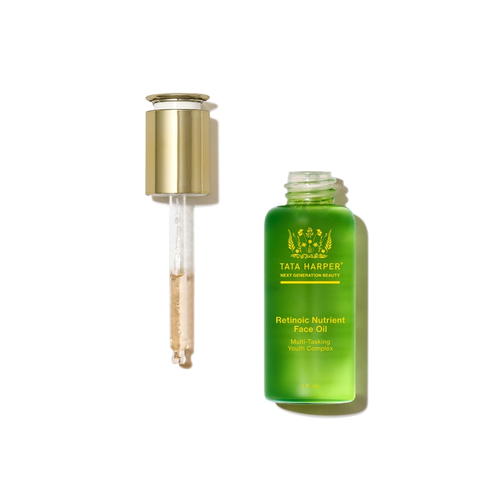Bottle of tata harper retinoic nutrient face oil with dropper applicator on a white background.