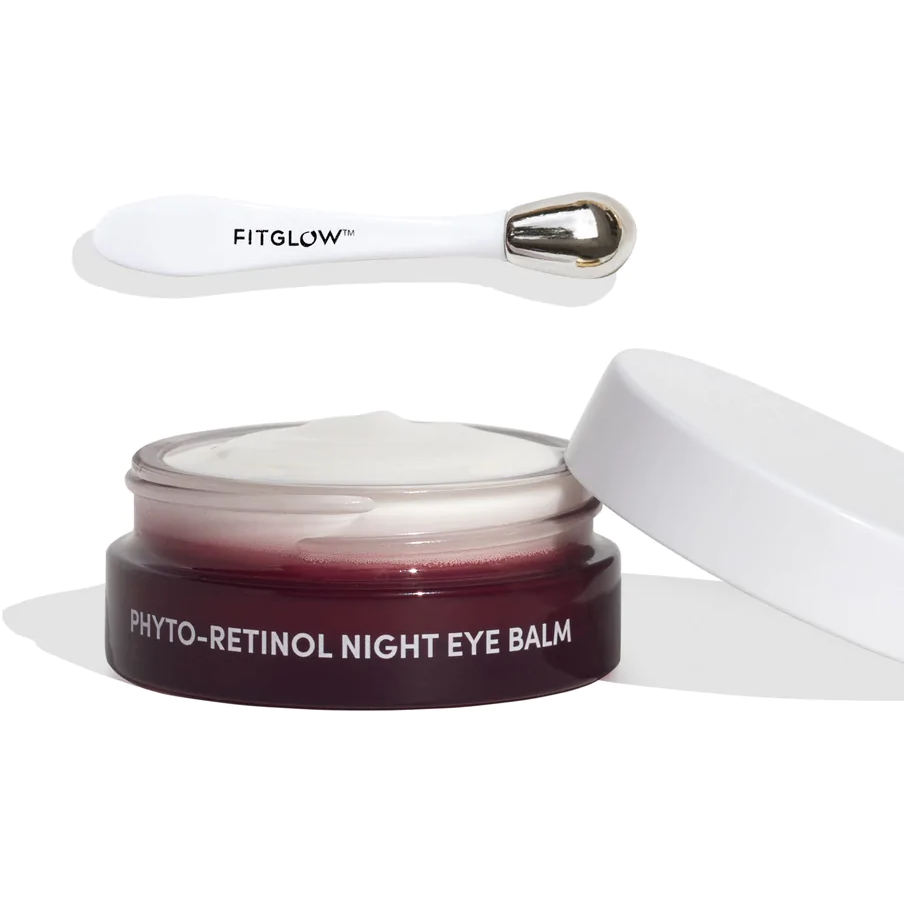 Eye balm product with applicator and open container displaying contents.
