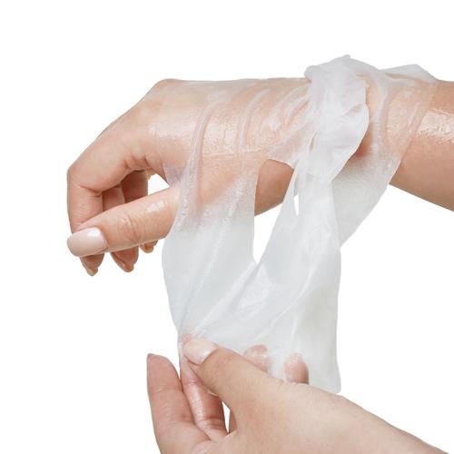 Peeling off a clear, skin-like substance from a hand.