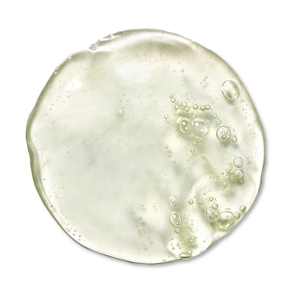 A clear gel substance with air bubbles spread on a white surface.