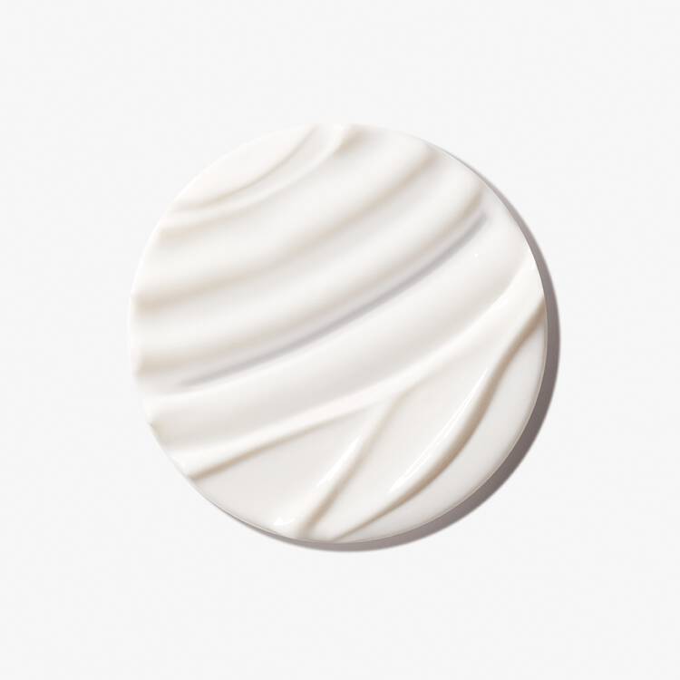 A dollop of creamy white substance with a smooth, swirled texture on a plain background.