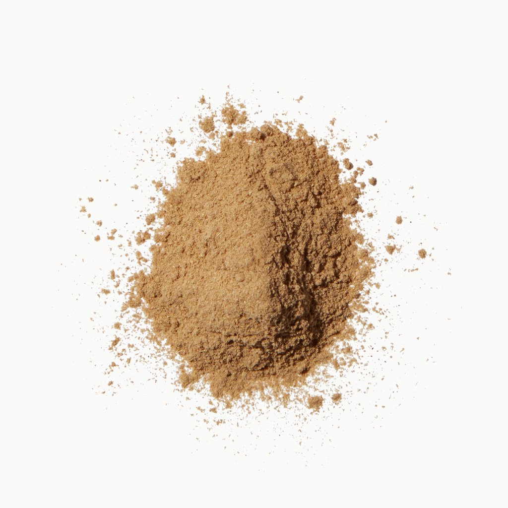A pile of loose, light brown powder scattered on a white background.