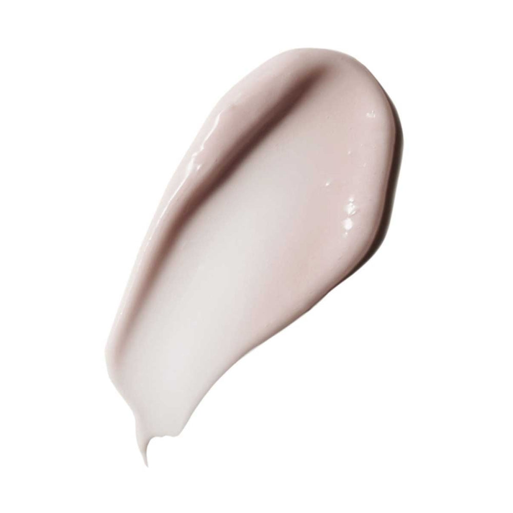 A smear of liquid foundation makeup on a white background.
