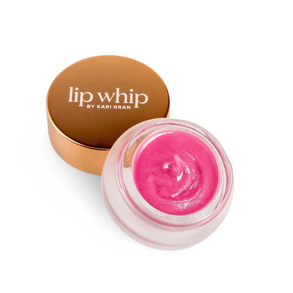 A pink lip whip in a clear jar with a copper-toned lid on a white background.