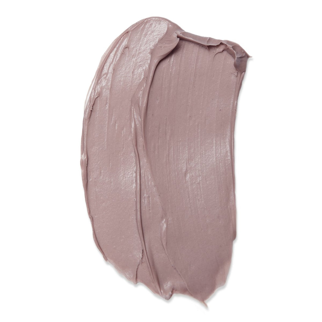 A smear of creamy, taupe-colored makeup foundation isolated on a white background.