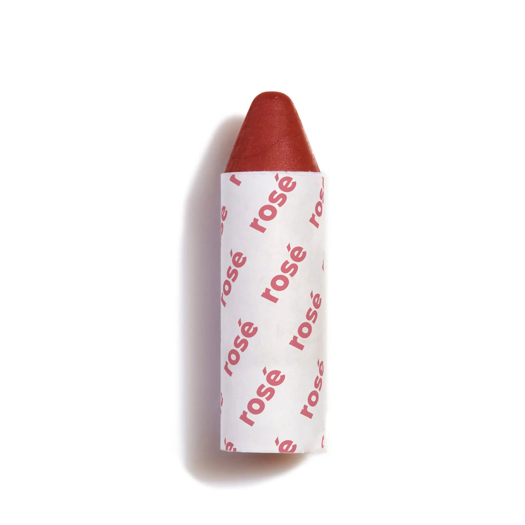 A red lipstick with a patterned label isolated on a white background.