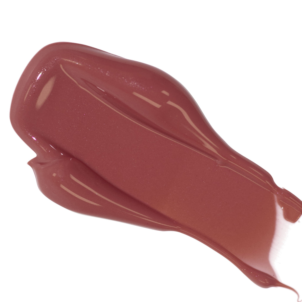 Smear of glossy brown lipstick on a white background.
