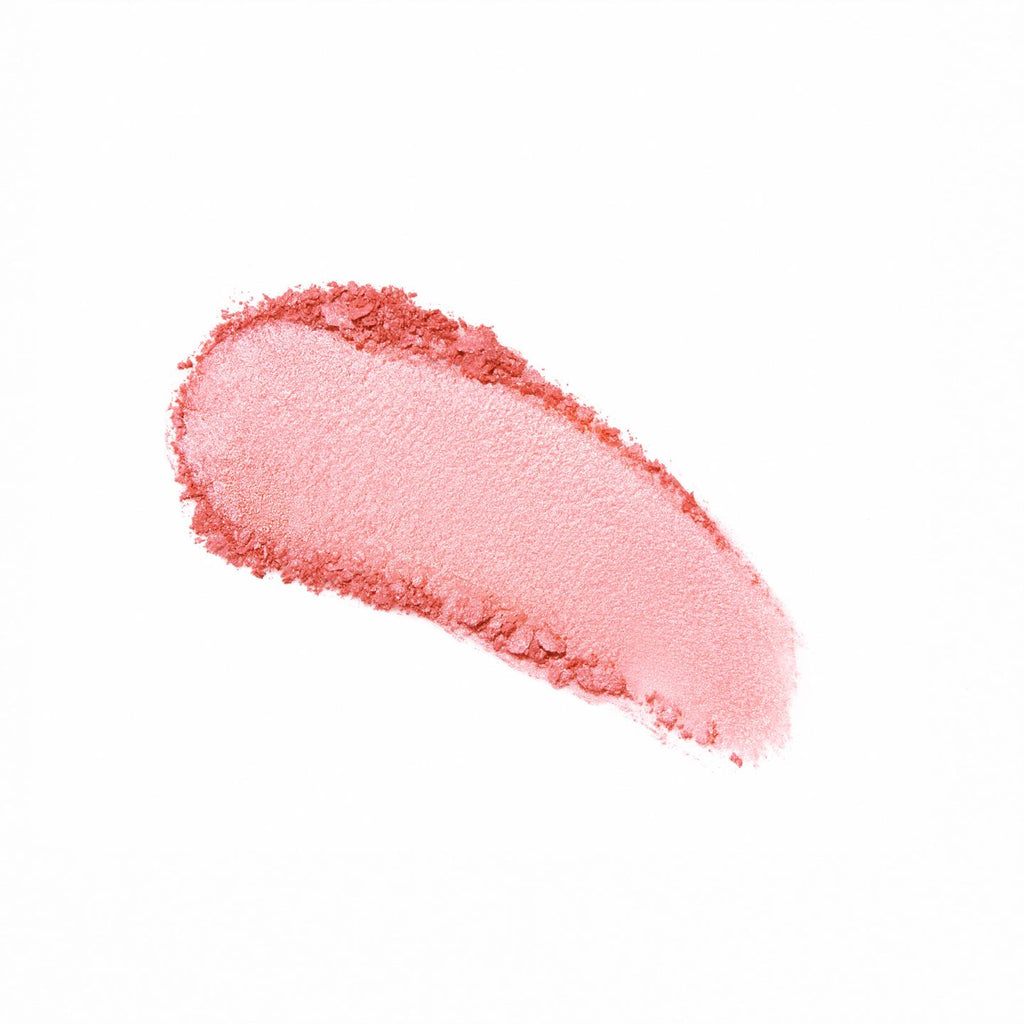 A swatch of pink lipstick smeared on a white background.