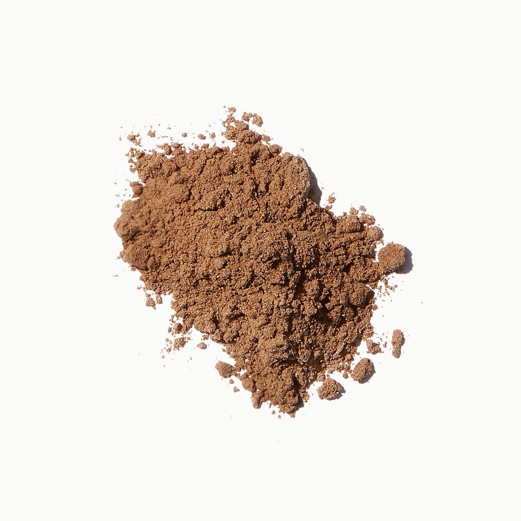 A pile of brown powder isolated on a white background.