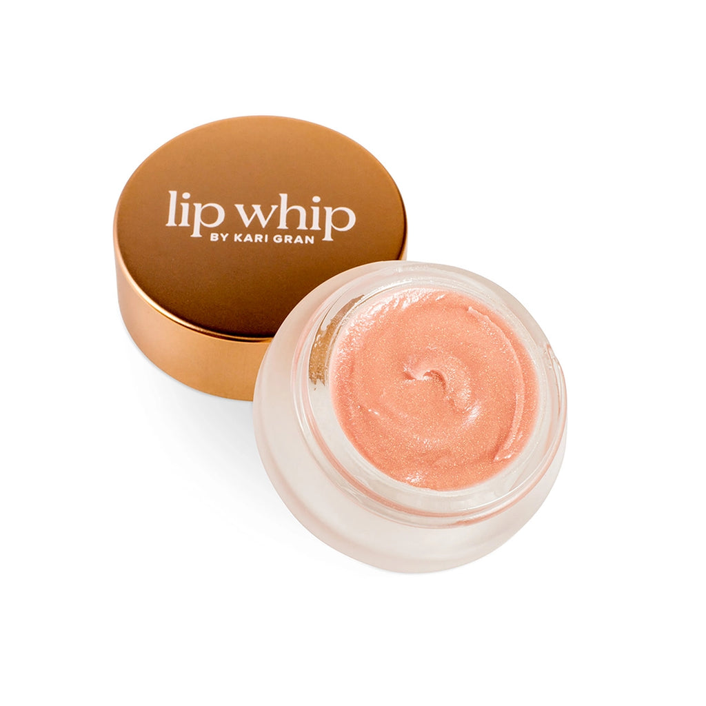 A jar of lip whip next to its complementary lid on a white background.