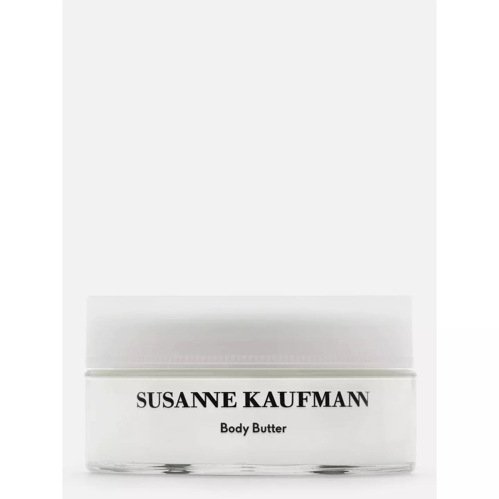 A jar of susanne kaufmann body butter against a white background.