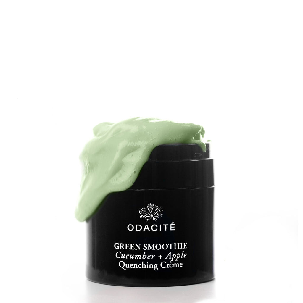 A jar of odacite green smoothie cucumber + apple quenching crÃ¨me with its content overflowing on the lid.