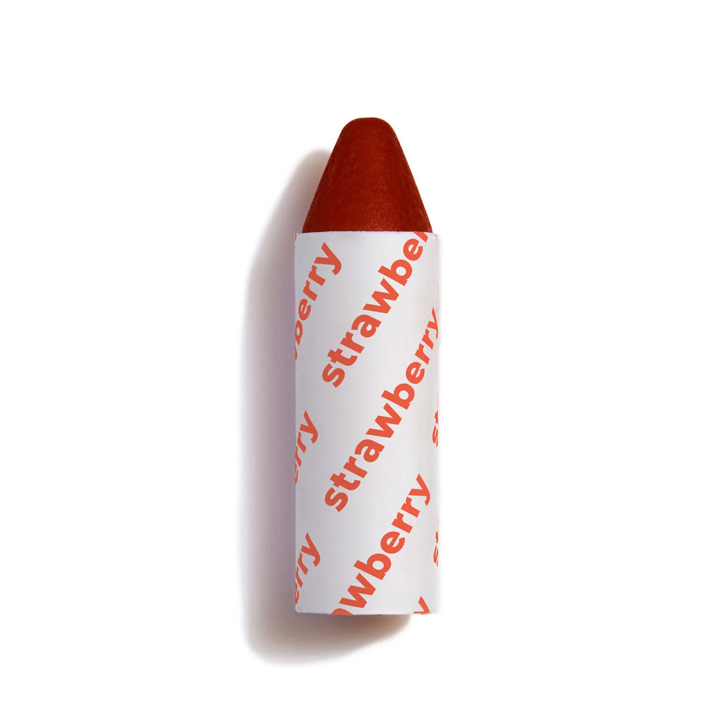 A strawberry-flavored candy with its wrapper partially unwrapped, isolated on a white background.