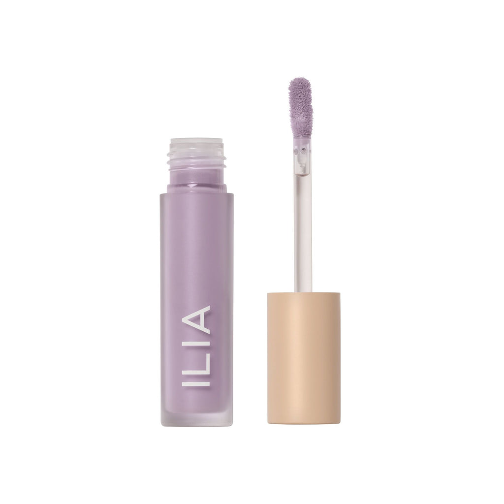 A bottle of ilia beauty product with an applicator wand.